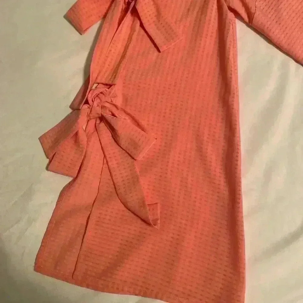 Cece beautiful peach blouse. This blouse has bell sleeves with tie closures. - Picture 6 of 7